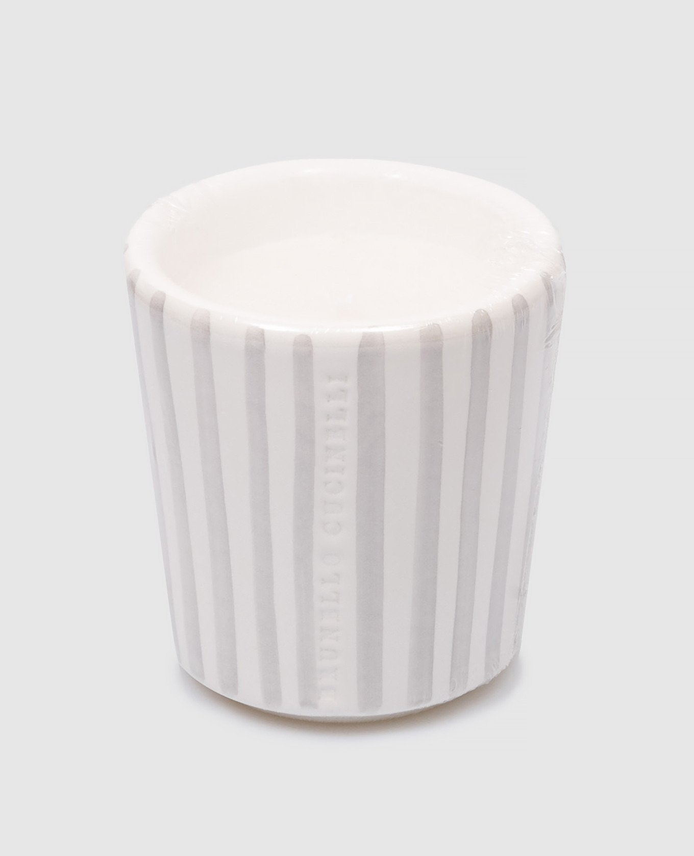 A white scented candle in a gray striped ceramic candle holder with a logo Brunello Cucinelli
A white scented candle in a gray striped ceramic candle holder with a logo Brunello Cucinelli