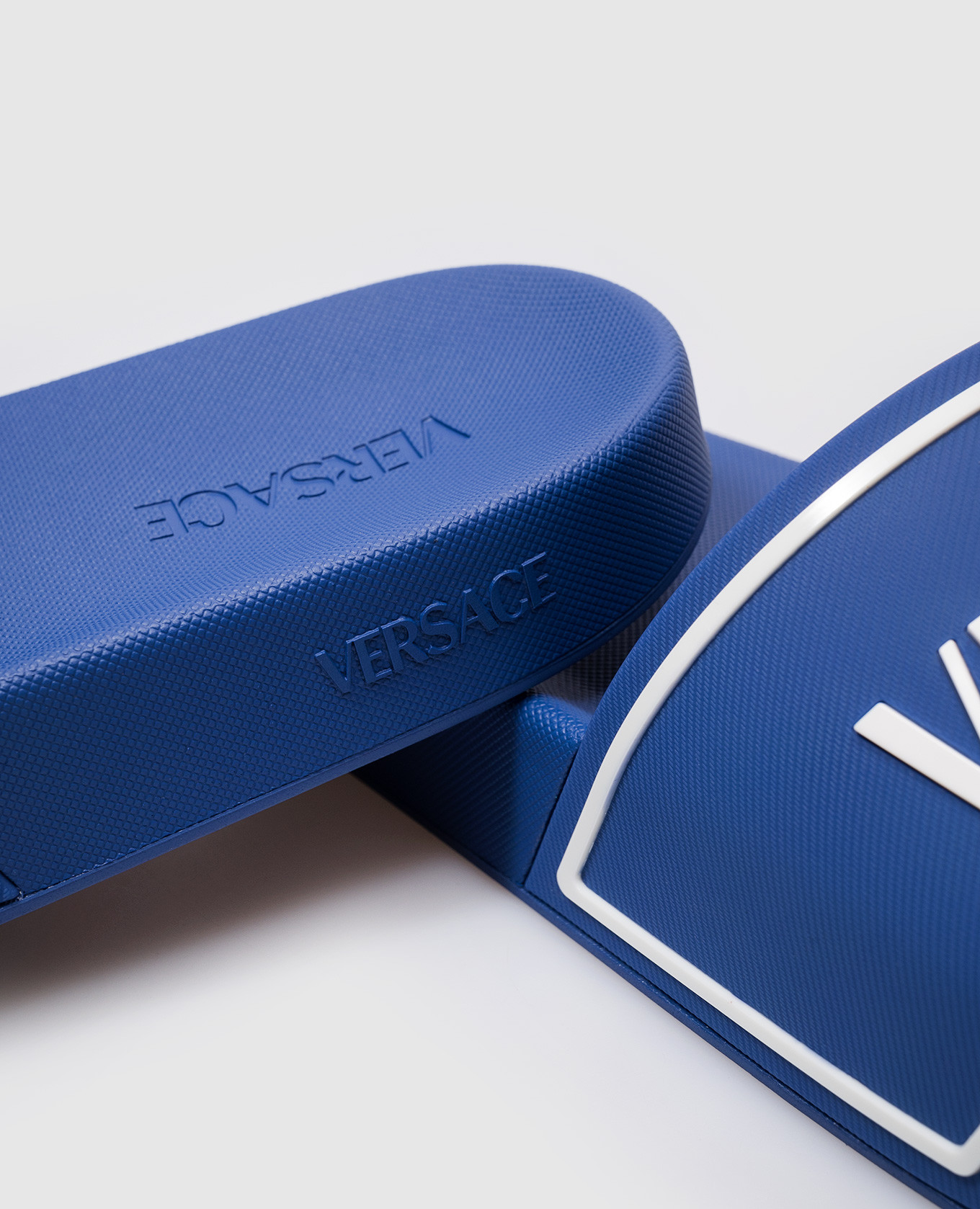 

Blue sliders with textured logo Versace