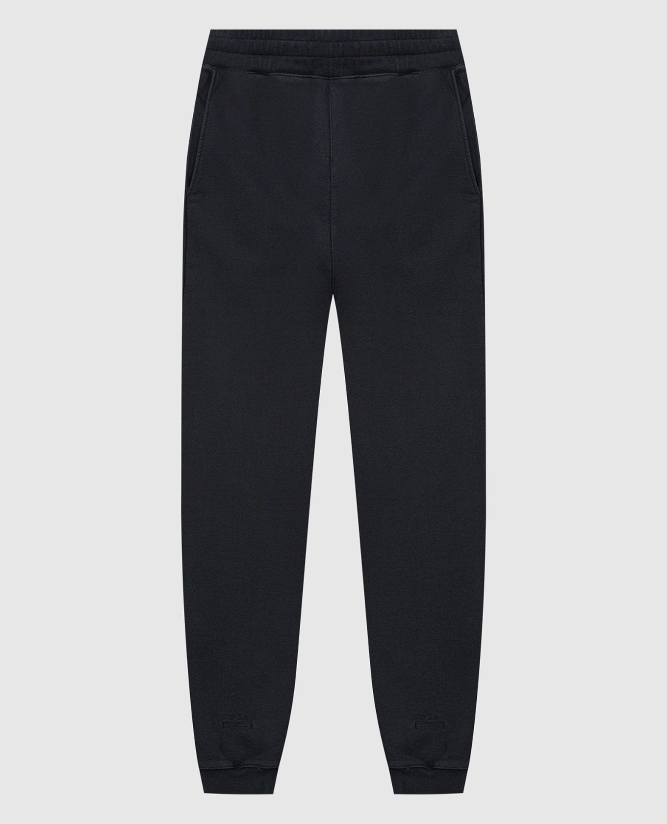Black joggers a cold wall