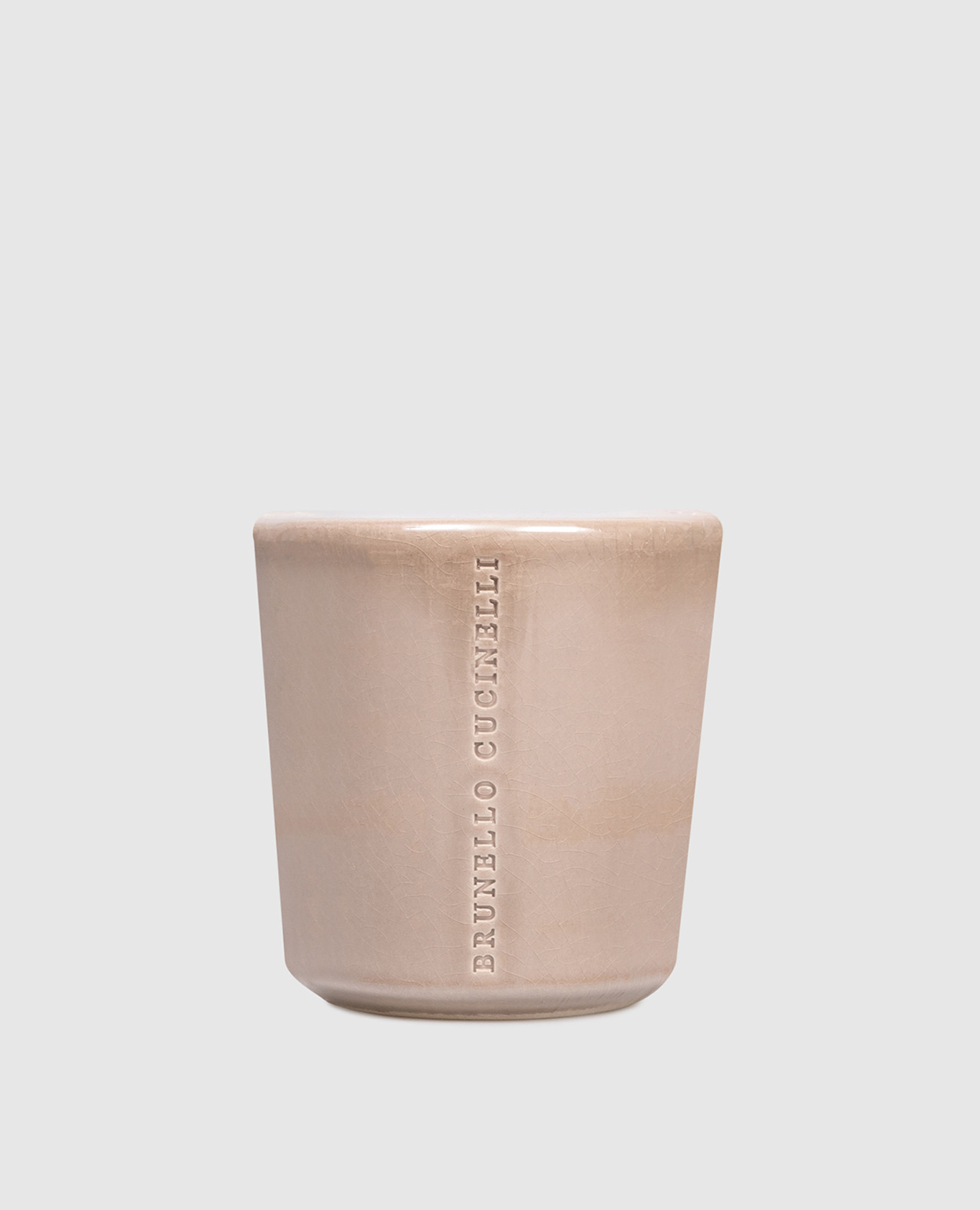 Beige candle in a ceramic candle holder with ebony and teak wood scent