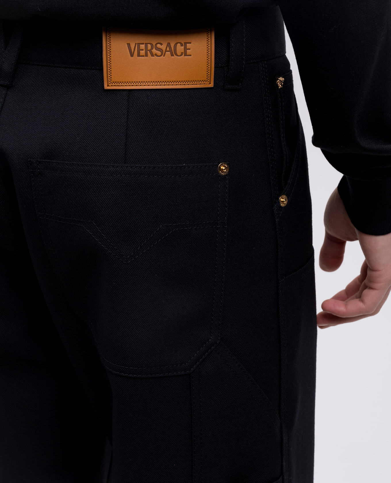 Black wool trousers with leather logo patch Versace 5