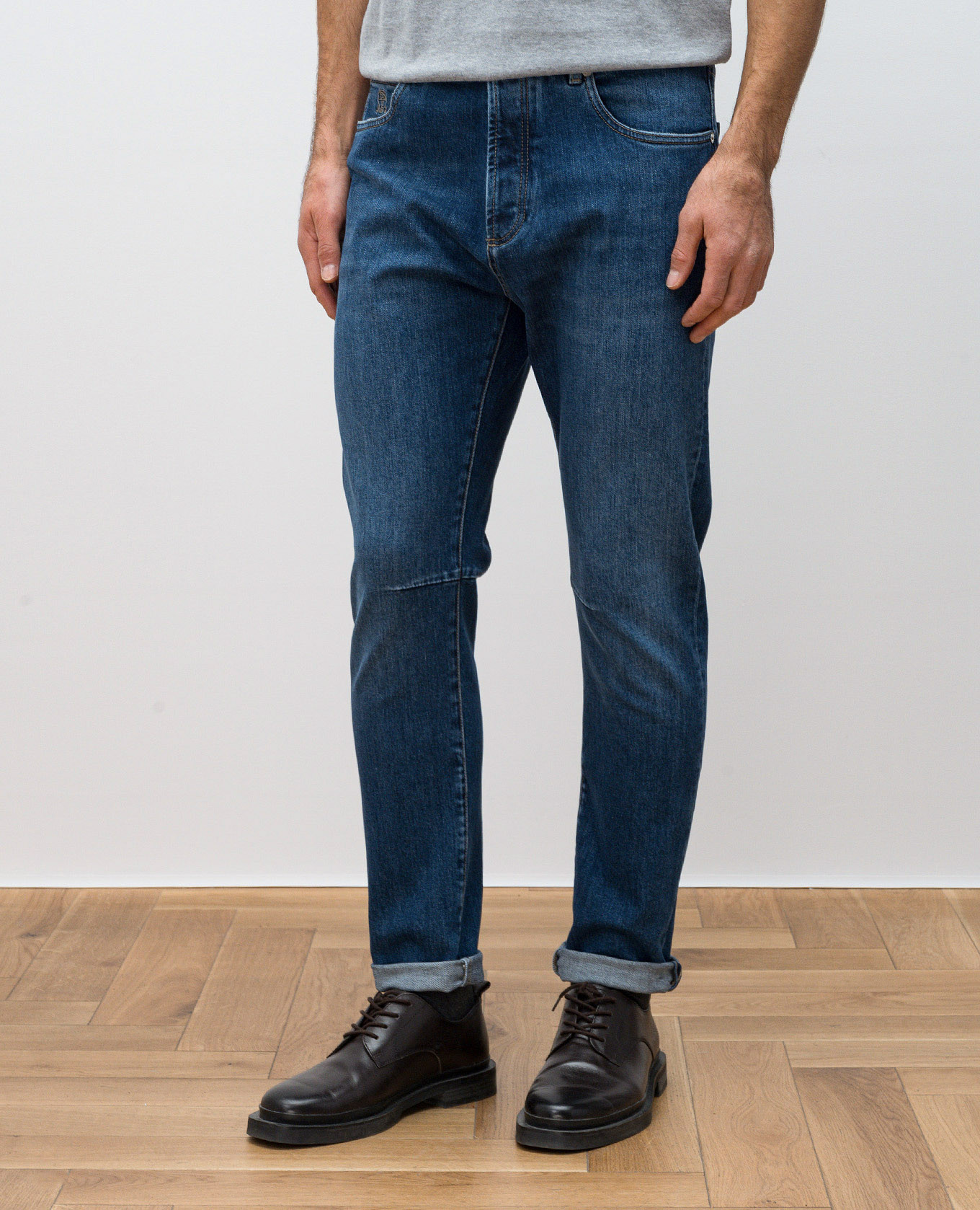 

Blue jeans with leather logo patch Brunello Cucinelli