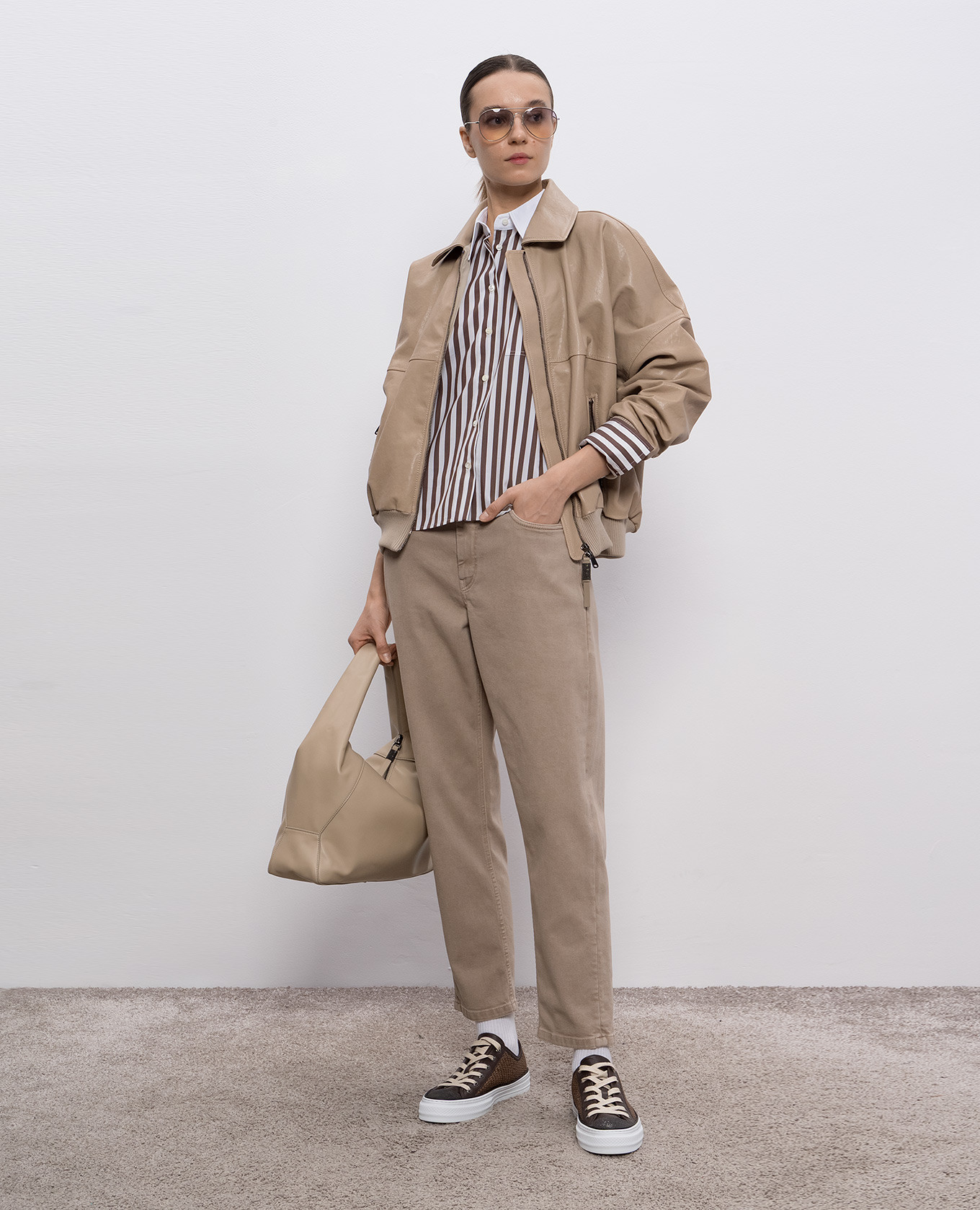 

Beige jeans with leather logo patch Brunello Cucinelli
