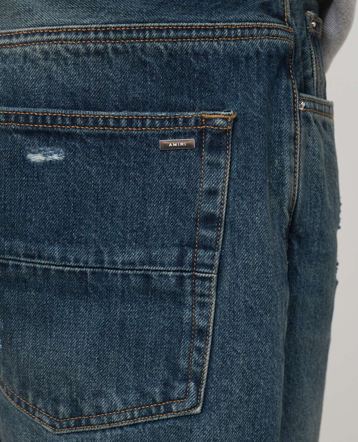 

Blue distressed jeans with logo AMIRI