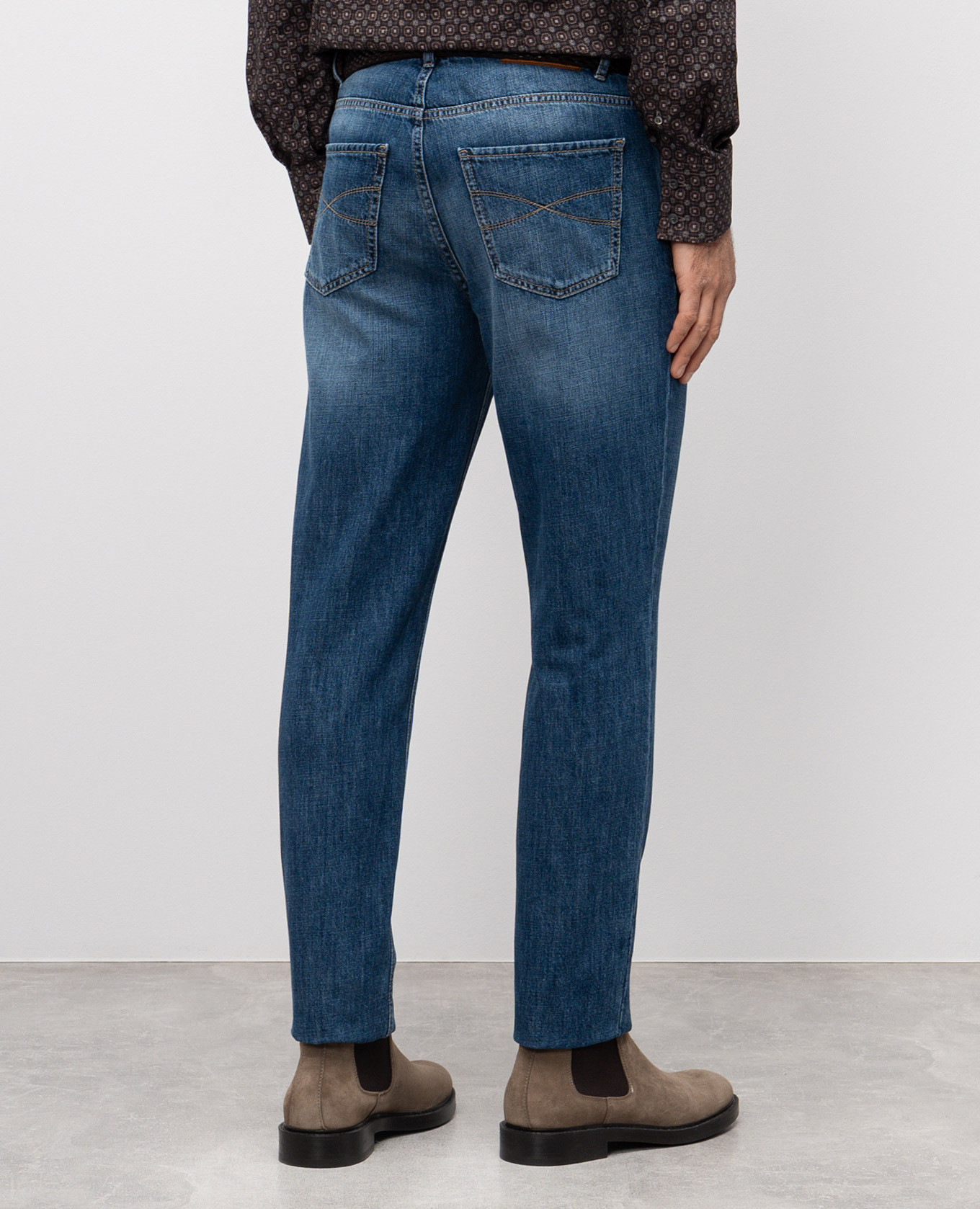

Blue jeans with leather logo patch Brunello Cucinelli
