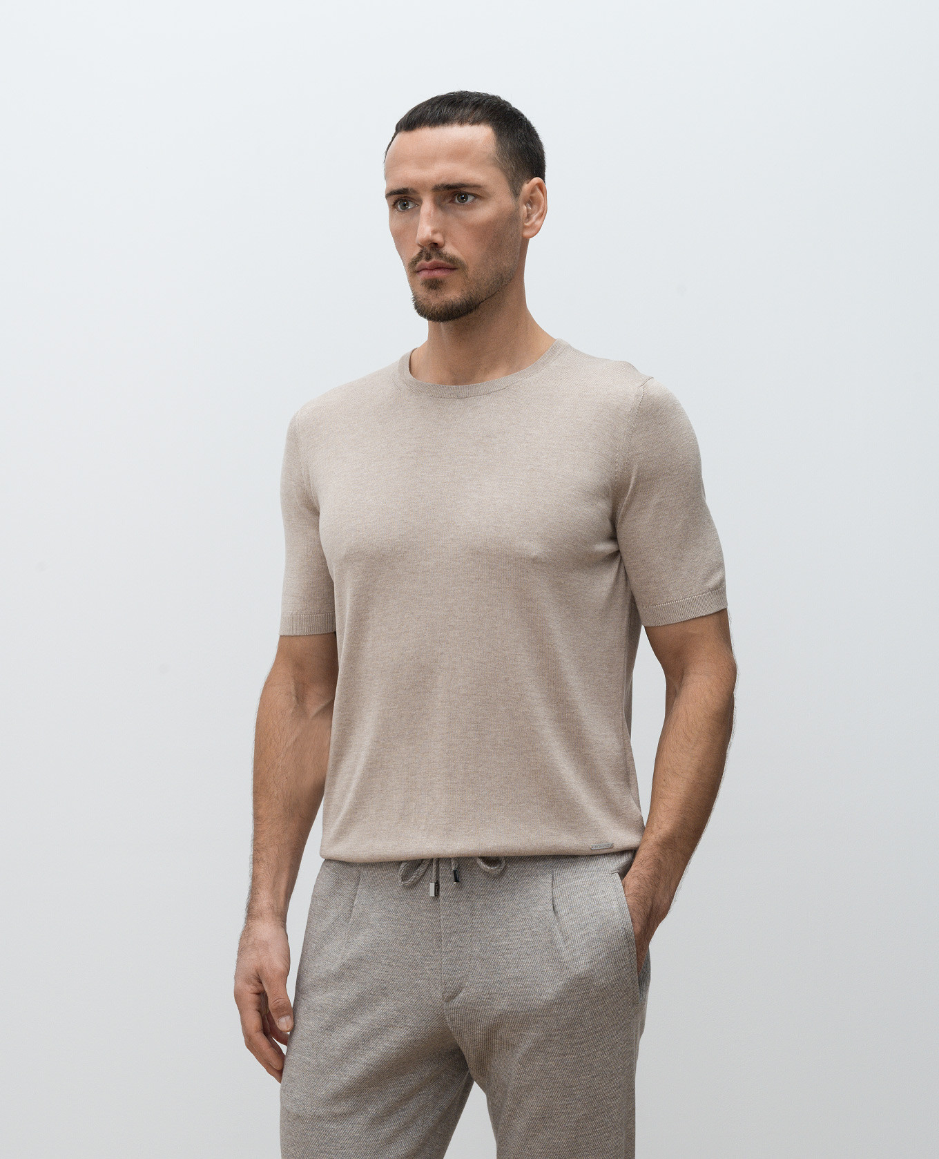 

Beige silk T-shirt with metal logo plate Enrico Mandelli