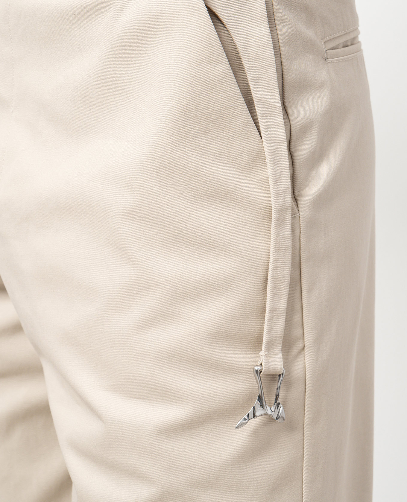 

Beige pants with a metal element Heliot Emil