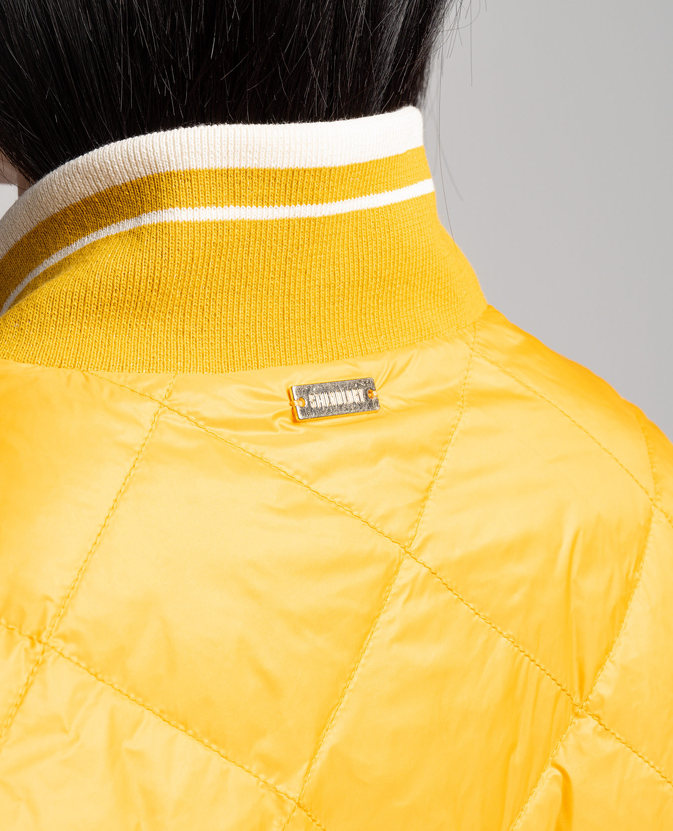 

Yellow quilted down jacket with metallic logo Stilnology