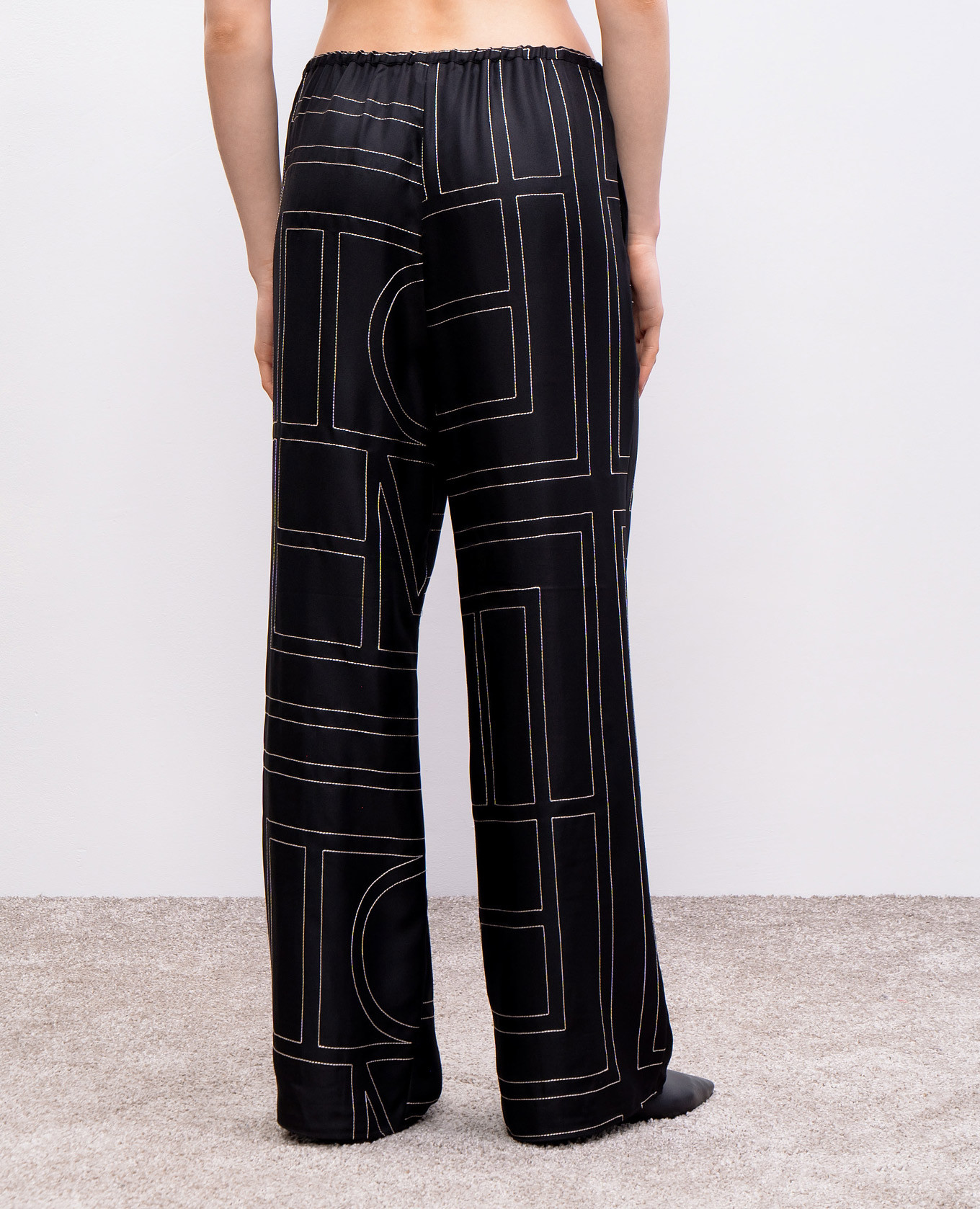 

Black silk trousers with embroidered monogram logo Toteme