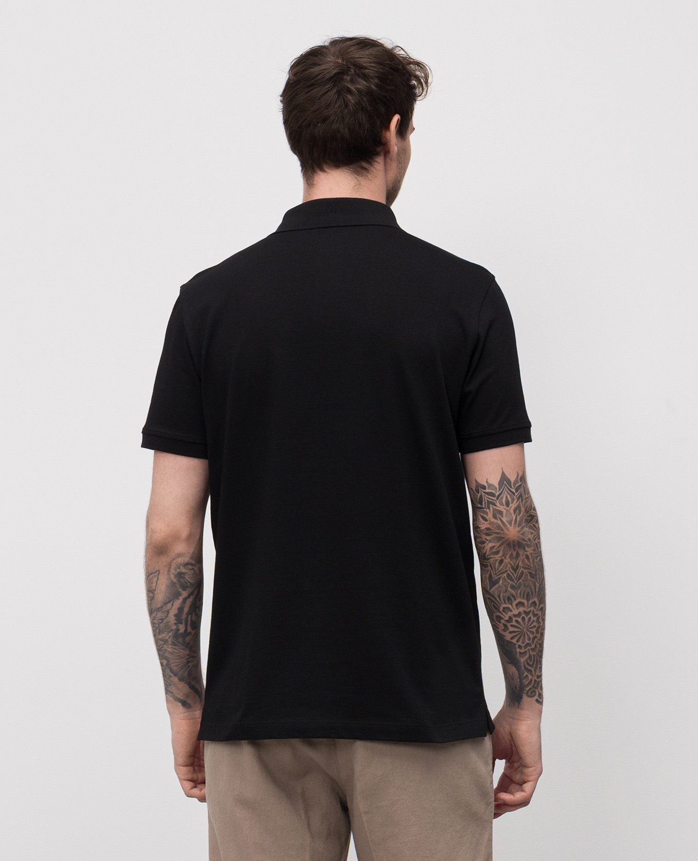 

Black polo with embroidered logo emblem CAPOBIANCO