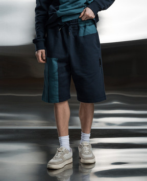 A Cold Wall Blue shorts with a branded print ACWMB282