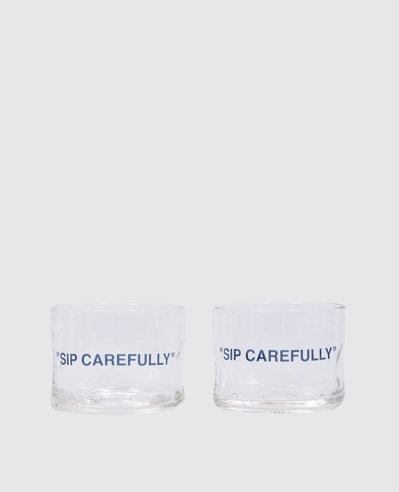 

A set of glasses with the inscription Sip Carefully Off-White, Transparent