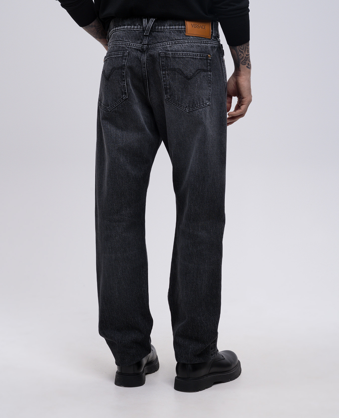 

Black jeans with leather logo patch Versace