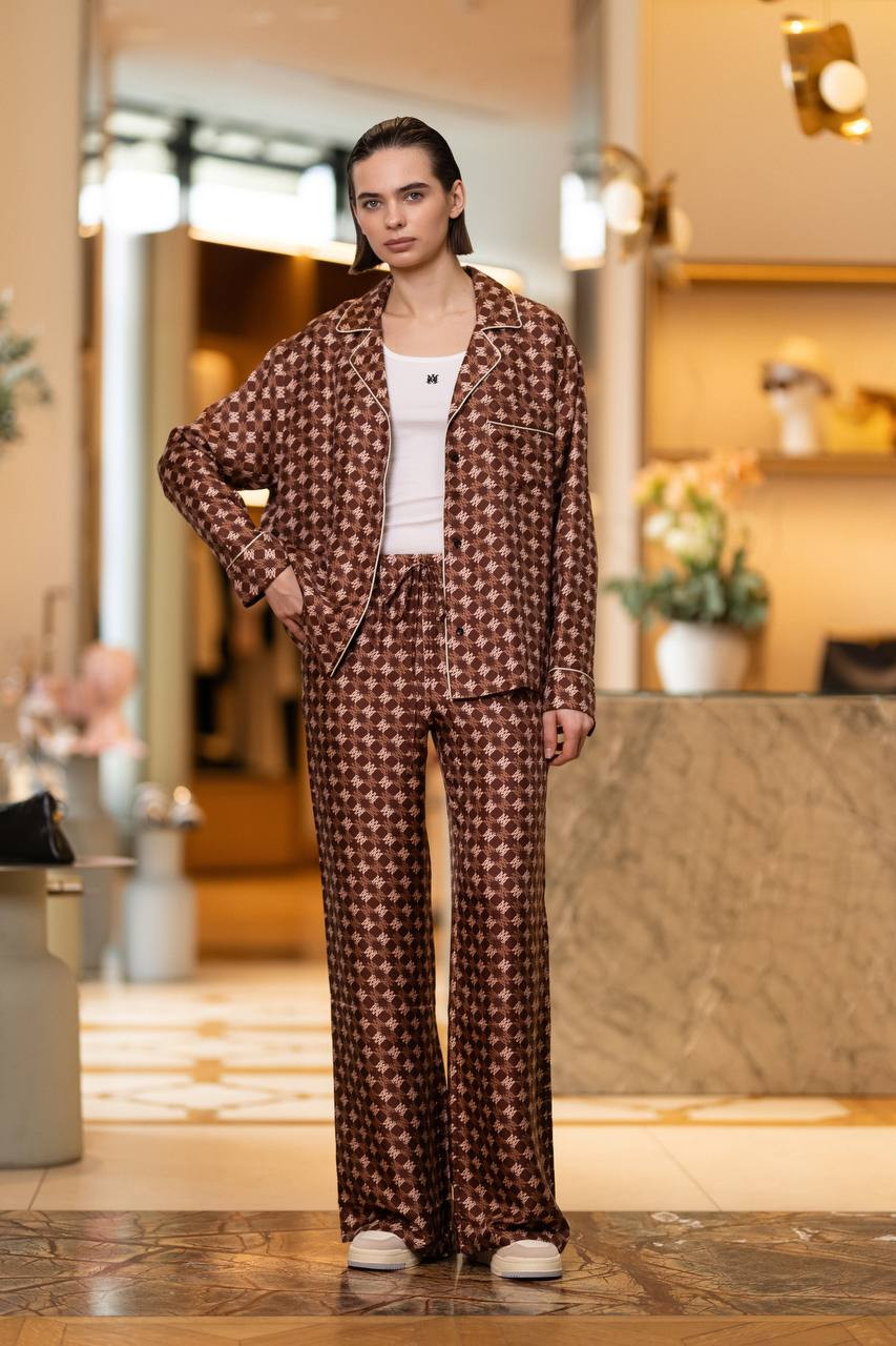 

Brown flared silk trousers with logo monogram print AMIRI
