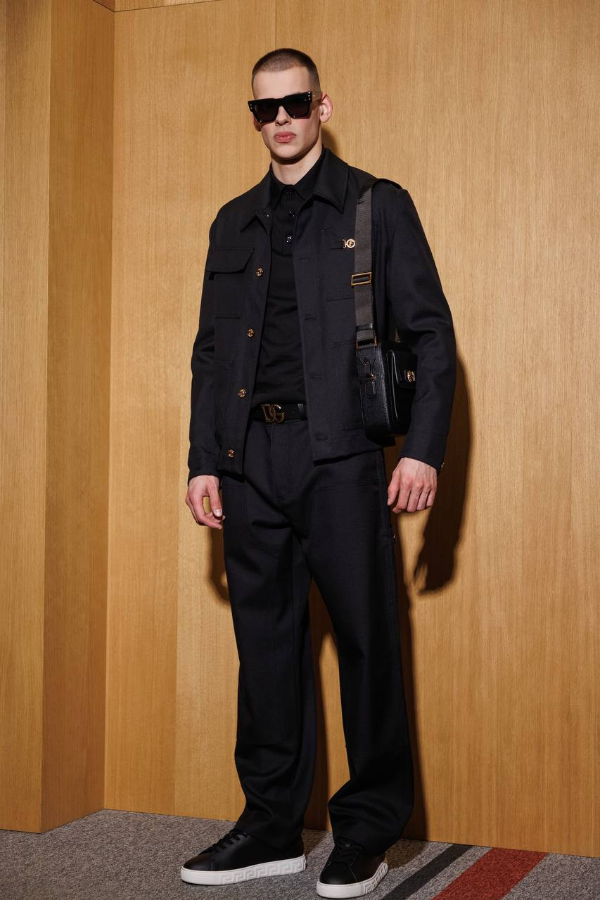 

Black wool trousers with leather logo patch Versace