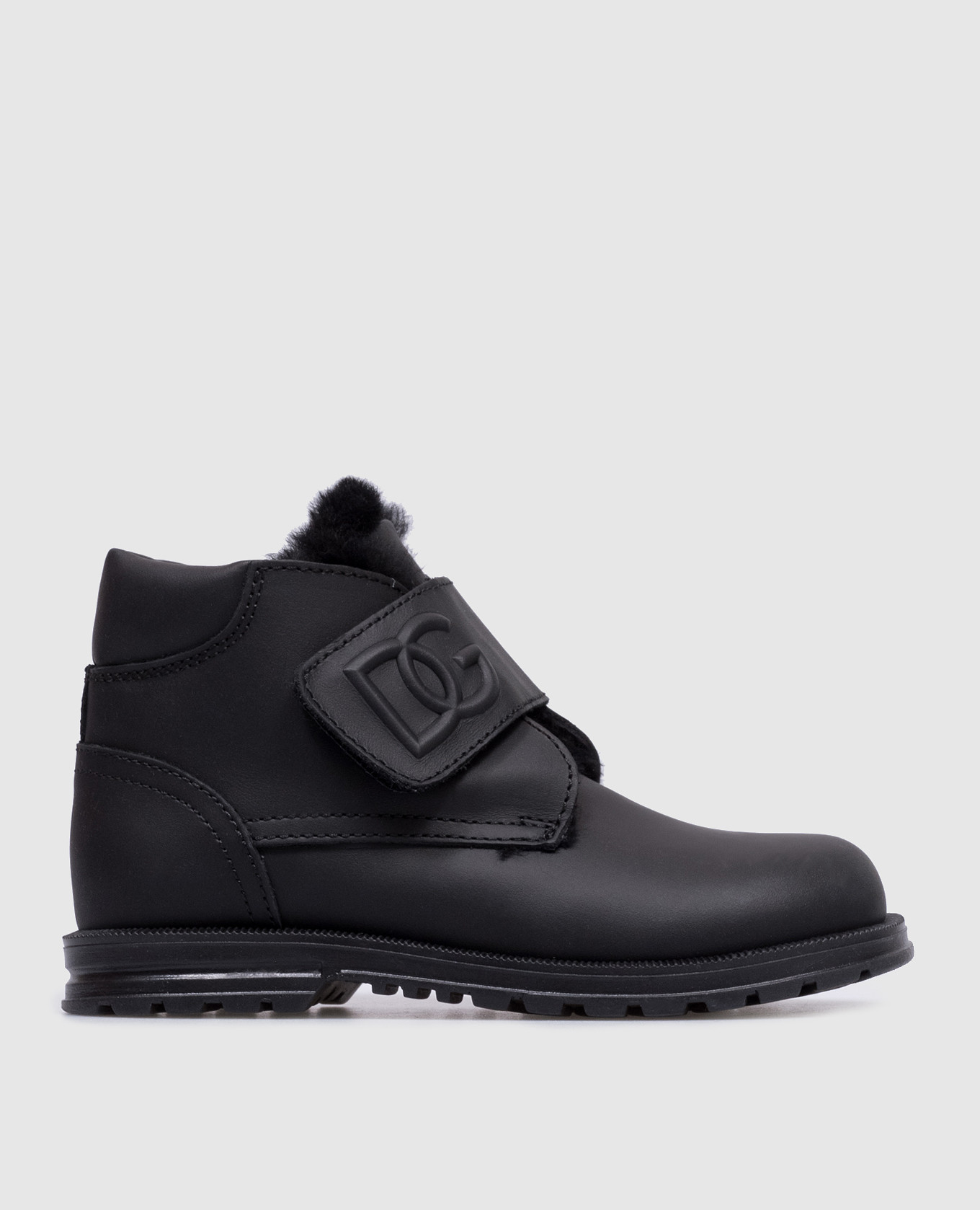 Children's black leather boots on fur with a textured logo dolce&gabbana