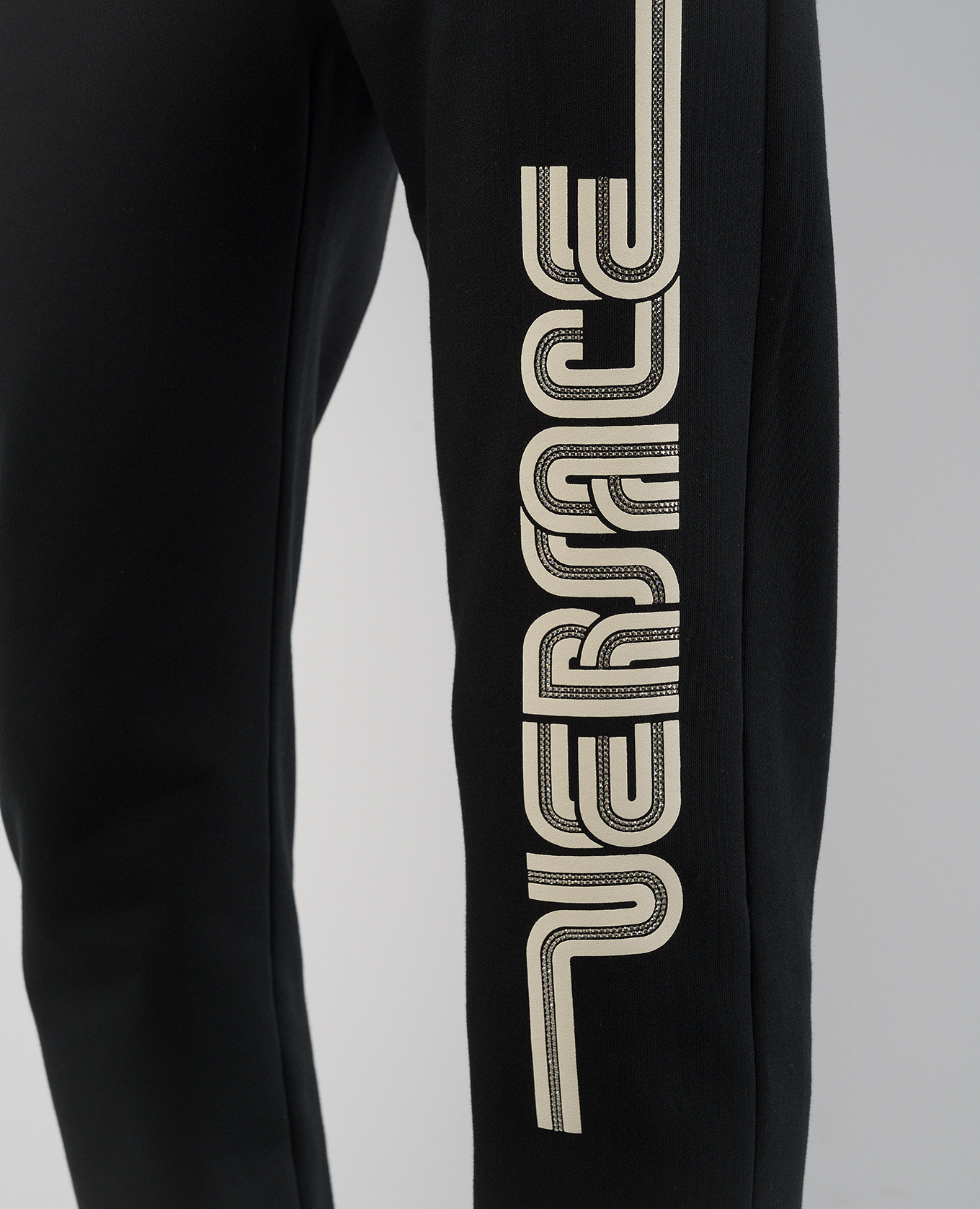 

Black joggers with textured logo print Versace